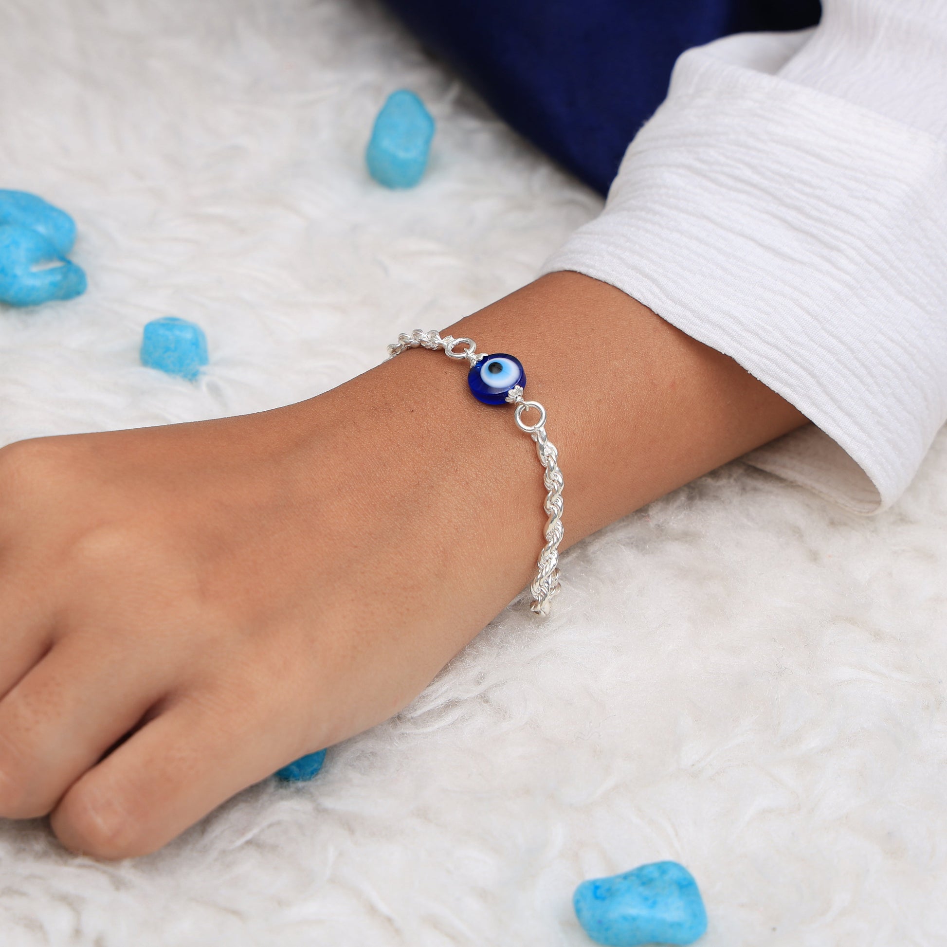 Sleek silver chain bracelet with an elegant evil eye charm