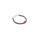 Elegant silver bracelet adorned with a red evil eye and black and silver beads.