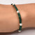 Stylish silver bracelet adorned with green and silver beads, tailored for boys.