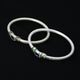 Stylish silver bangles adorned with a beautiful, colorful center.