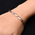 Boys' bracelet featuring a sleek sterling silver design with interconnected arrows.