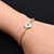 Boys' bracelet with a sterling silver band adorned with an evil eye and heart motif.