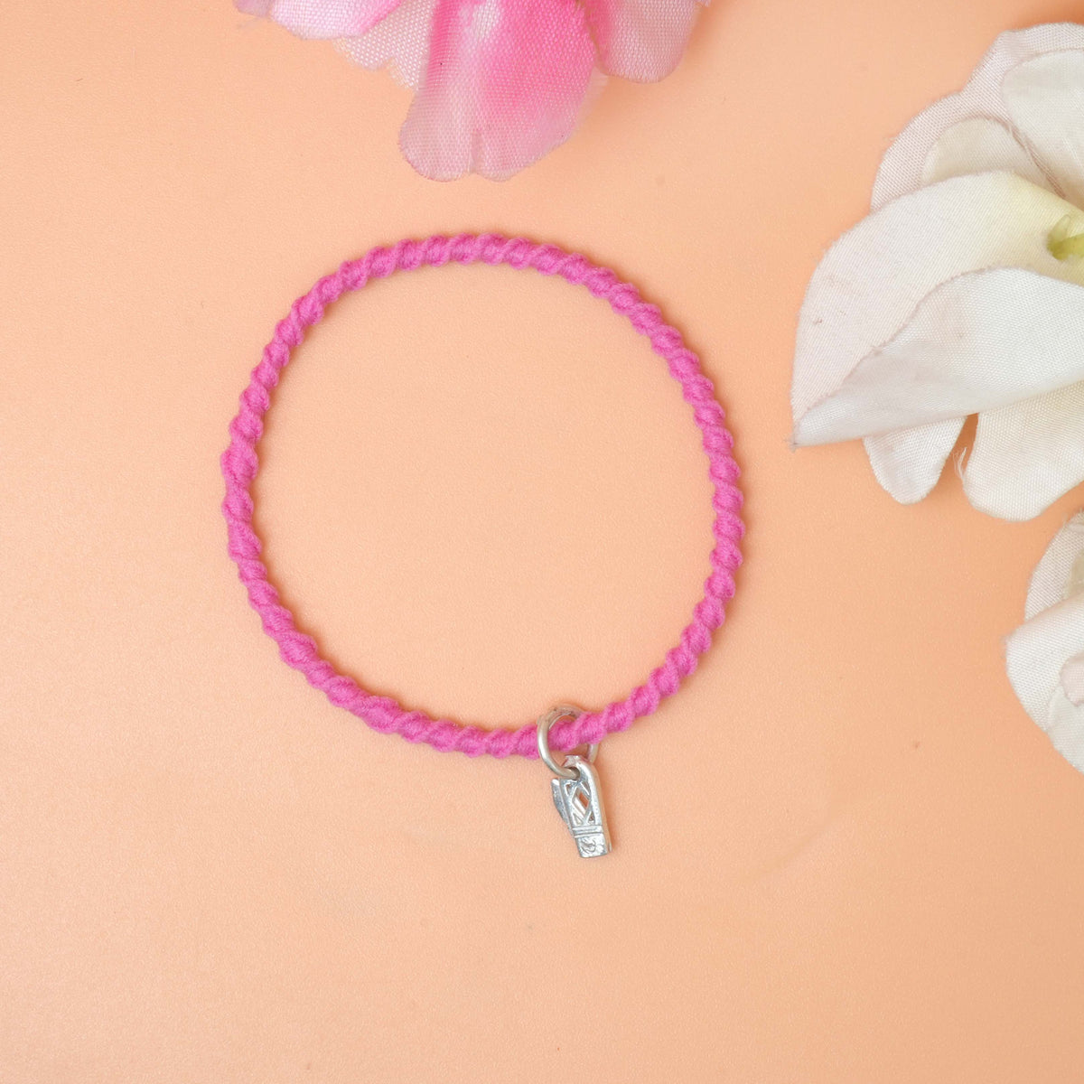 A stylish bracelet featuring a shiny silver knife charm