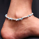 Elegant silver anklet featuring a delicate design of beads.