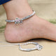 Girls' silver anklet featuring pink and green gem stones.