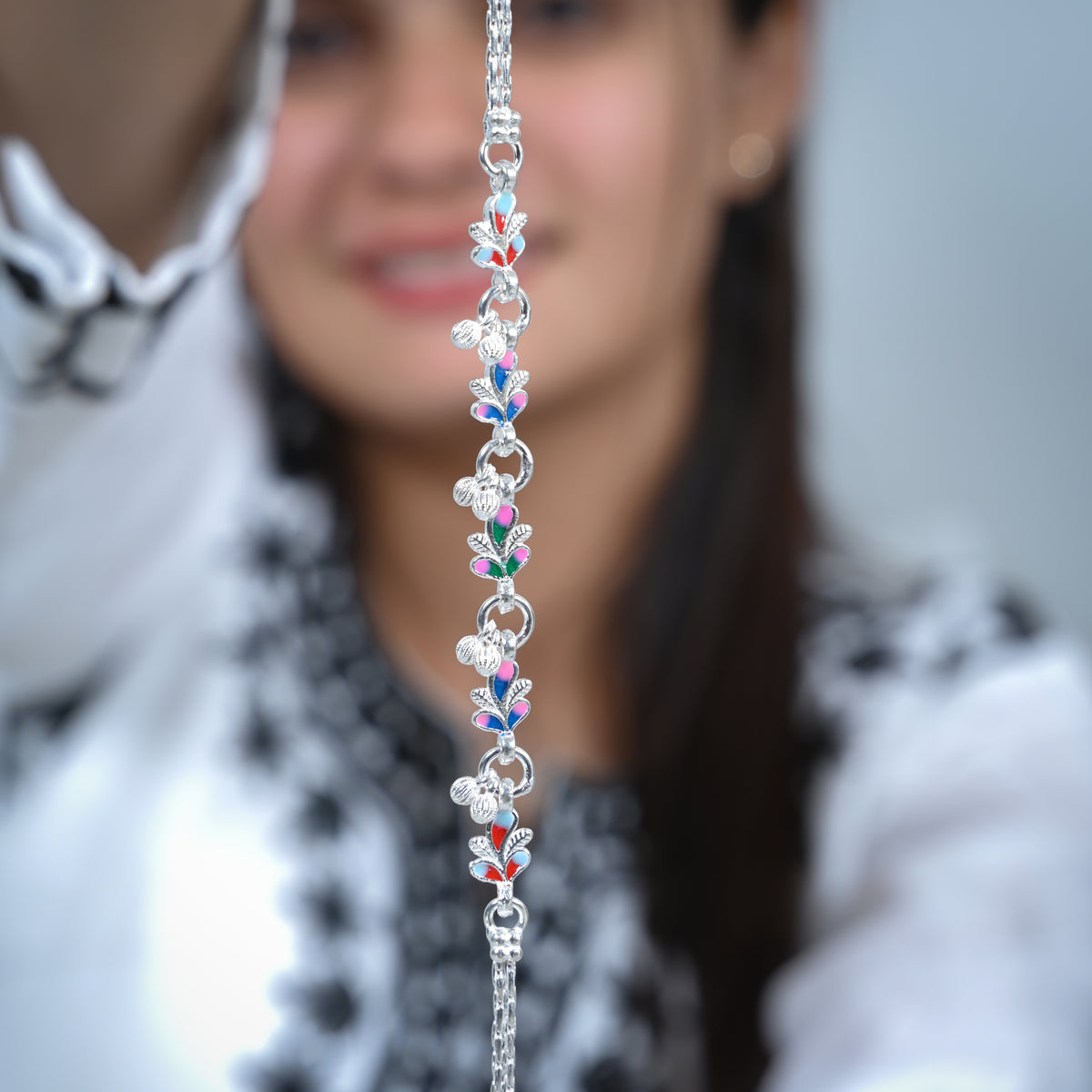 Silver anklet with detailed buds and vibrant colorful design for elegance