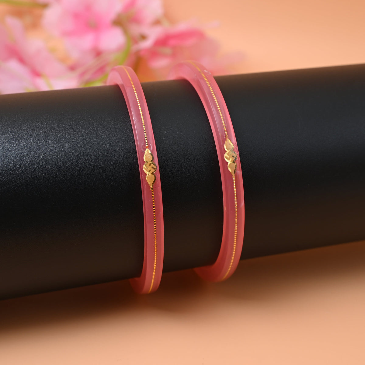 Gold small swastika design pink bangle