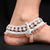 Trendy silver anklet with beautiful floral designs and premium orange accents.