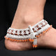 Trendy silver anklet with beautiful floral designs and premium orange accents.