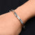 Boys' bracelet featuring a sterling silver band with a half-blade and connecting pattern.