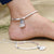 Anklet featuring silver sea shell, beads, and ghungroo details.