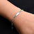 Elegant sterling silver bracelet with a green star motif.