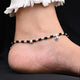 Elegant sterling silver anklet with blue gem stone, silver, and black beads.