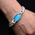 Silver bracelet with a central blue stone and chain design for men.