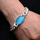 Silver bracelet with a central blue stone and chain design for men.