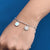 Elegant silver bracelet with a flower-shaped evil eye charm.