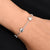 Silver bracelet featuring symbols of the Great Brand Apple design.