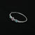 Stylish silver bracelet adorned with randomly colored minimal gemstones.