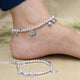 Girls' silver anklet featuring heart design and gem stones.