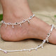 Elegant silver anklet featuring colorful flowers and leaf designs.