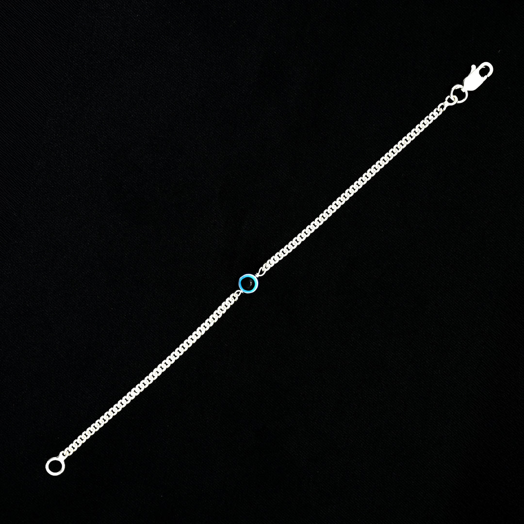 Fashionable silver bracelet with blue evil eye for a protective look.