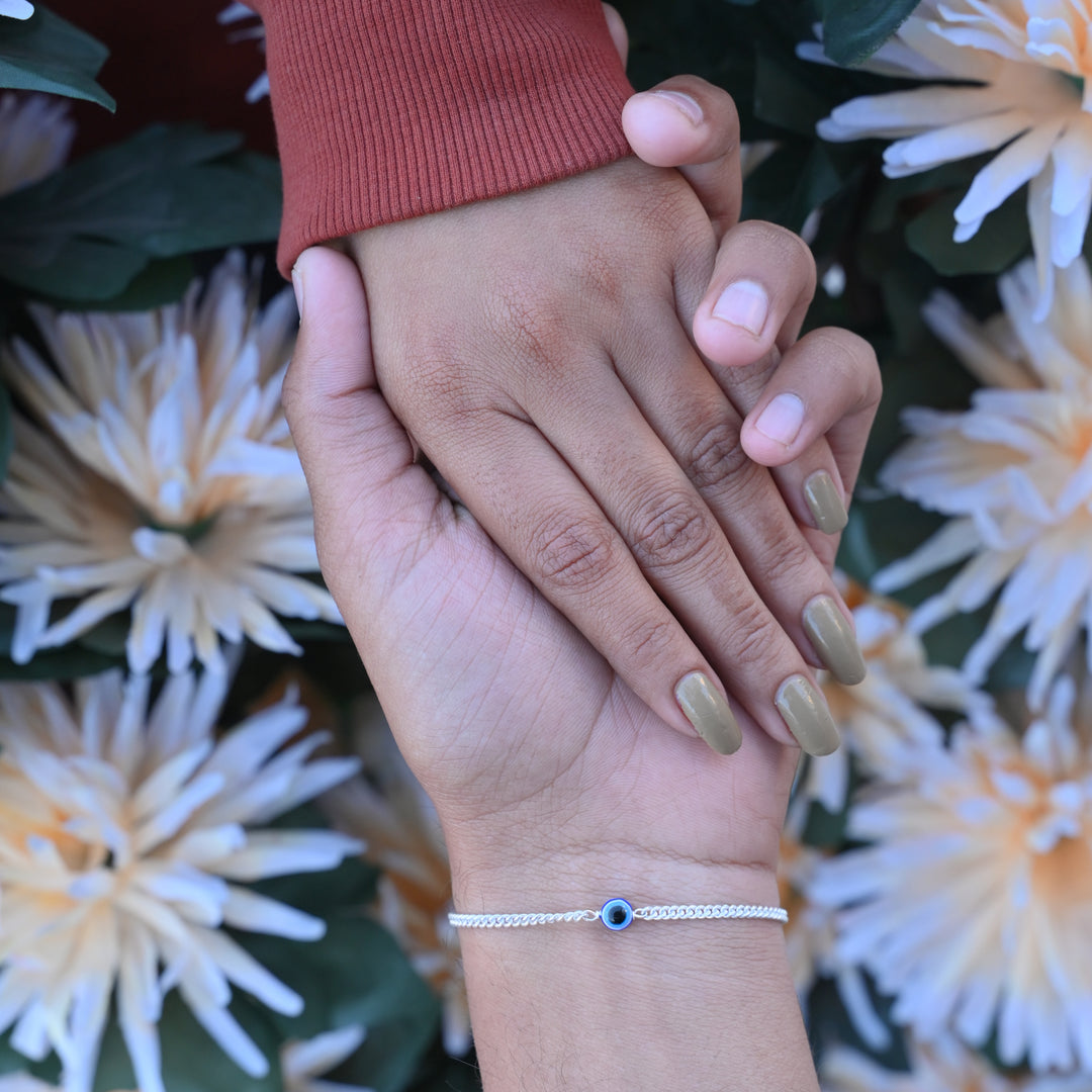 Stylish silver bracelet featuring blue evil eye for spiritual protection.