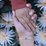 Load image into Gallery viewer, Stylish silver bracelet featuring blue evil eye for spiritual protection.
