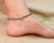 Silver anklet with center evil eye, black, and silver beads for girls.