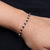 Elegant silver bracelet with black beads, tailored for girls.