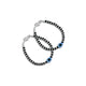 Silver bracelet featuring an oval evil eye charm with black beads.