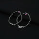 Stylish silver baby bracelet with a pink evil eye and a mix of black and silver beads.