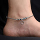 Elegant sterling silver anklet with heart and evil eye charms.