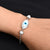 Silver bracelet featuring smash beads and an evil eye charm.