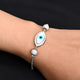 Silver bracelet featuring smash beads and an evil eye charm.