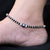 Heart-shaped silver anklet featuring evil eye design.