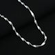 Elegant silver chain featuring spiral curve details, perfect for women.