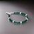 Elegant silver bracelet adorned with green beads for boys.